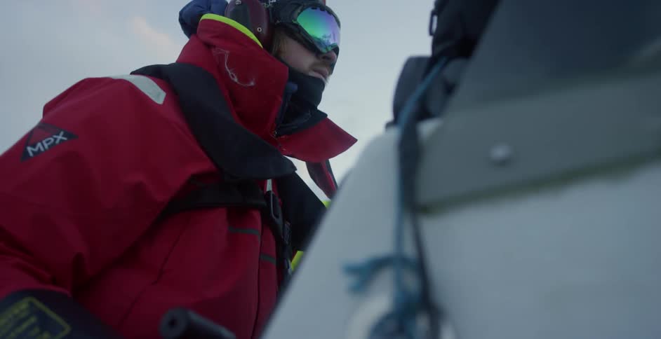 People in protective gear bob up and down in a boat