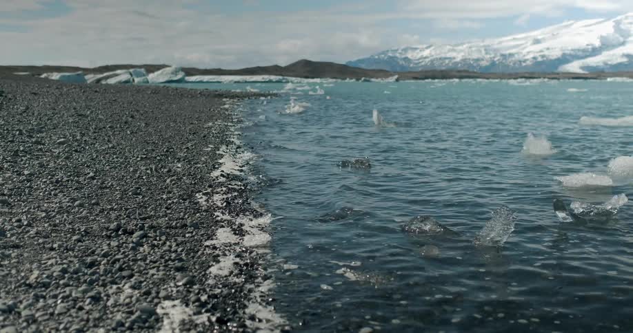 Water flows onto the rocky shore