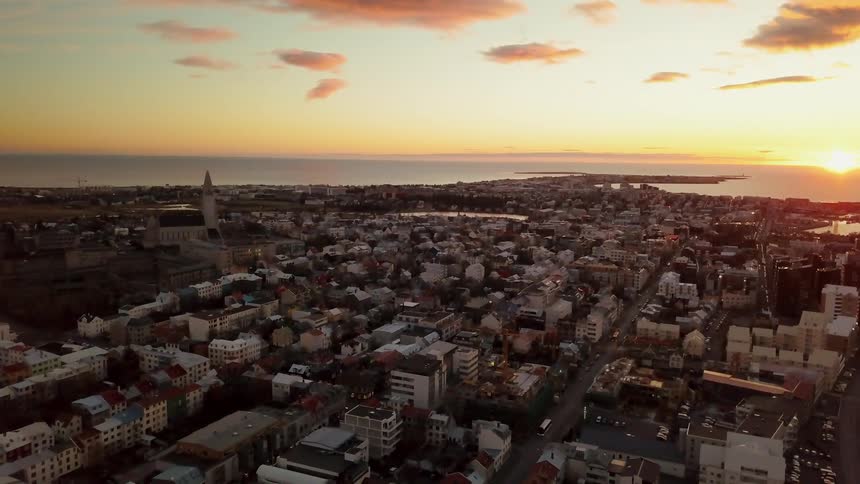 The sun shines on a town on the shore