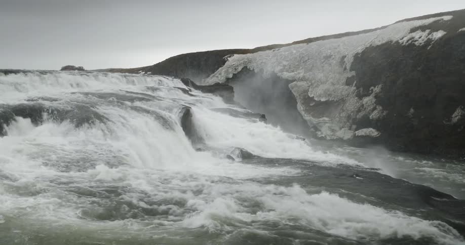 Water flows down an icy stream
