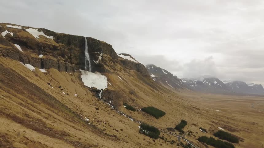 Water flows off the side of a cliff
