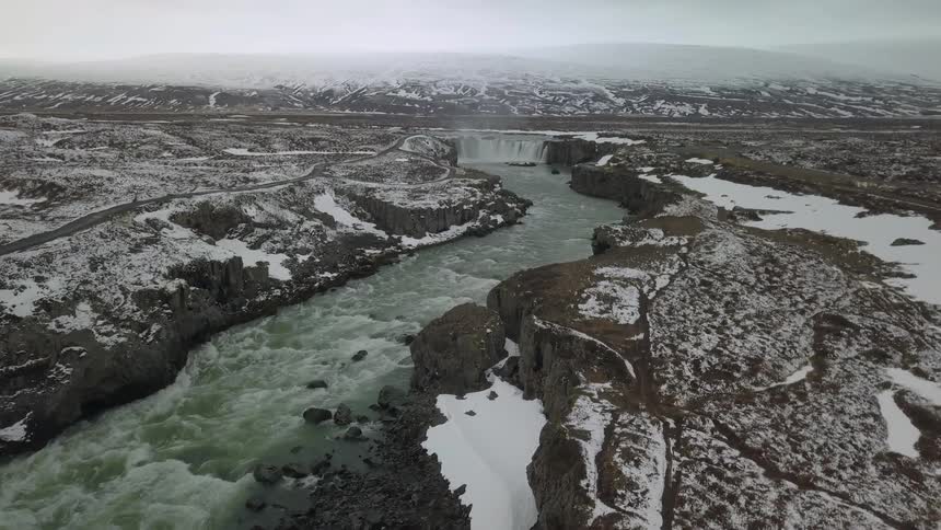 Water flows down an icy stream