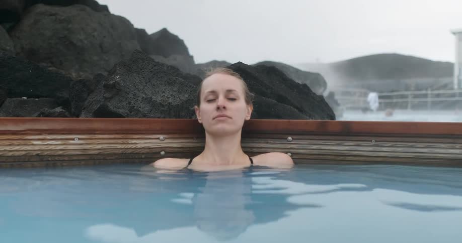 Woman relaxing in blue lagoon hot springs