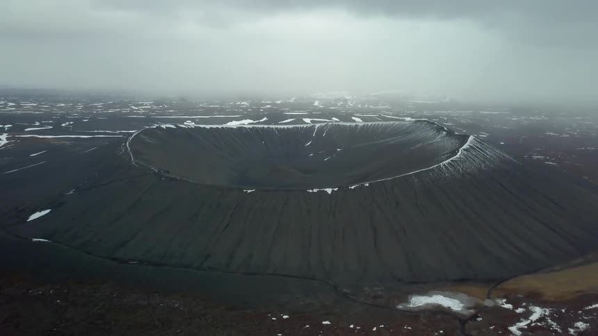 Snow and ice cover the rim of a crater