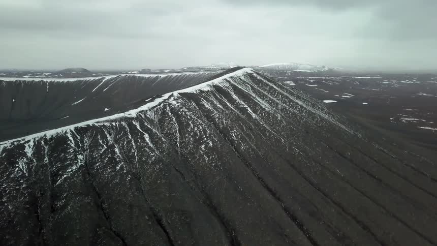 Snow and ice cover the rim of a crater