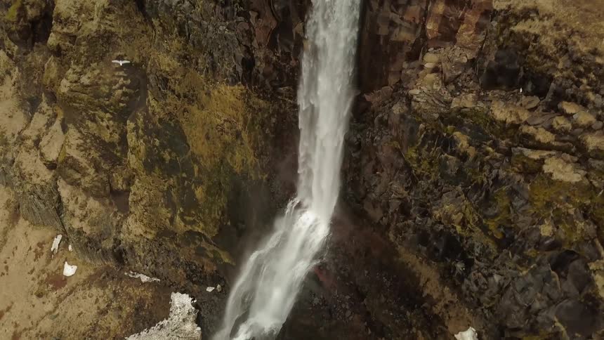 Water falls off the side of a cliff