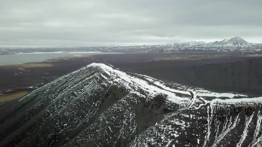 Clouds are hovering over a remote mountain coast during the day