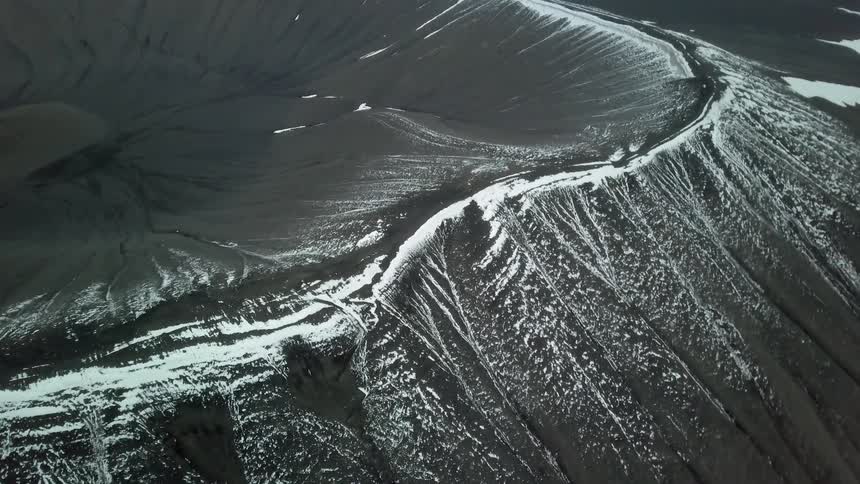 Snow and ice cover the rim of a crater