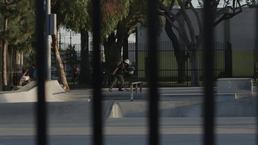 Teenagers are riding skateboards in a skatepark during the day