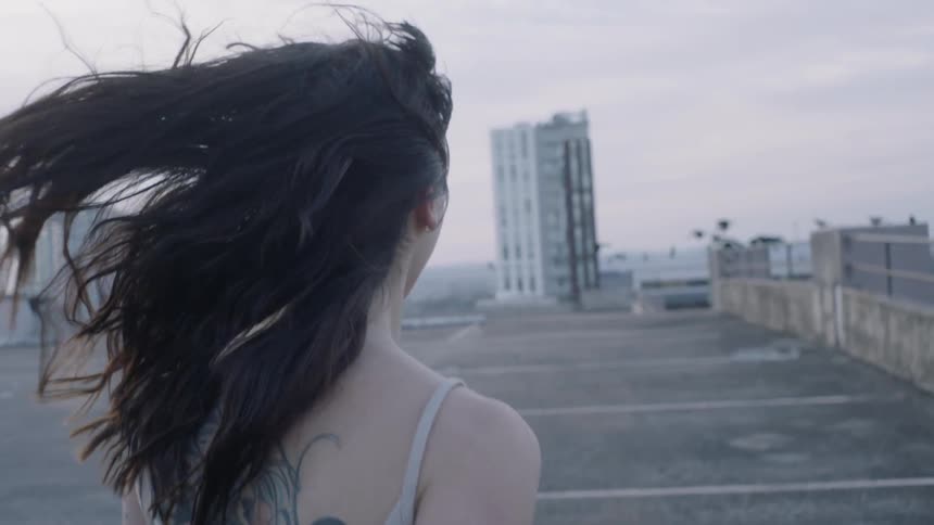 A woman is running on a rooftop