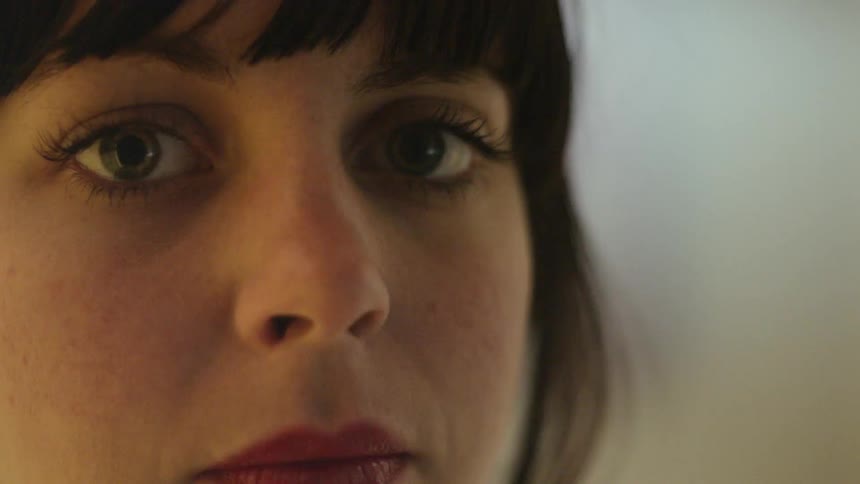 A woman with dark hair is staring at something