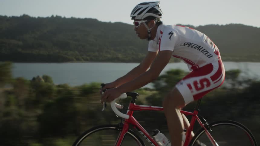 Man riding on a hill beside a lake