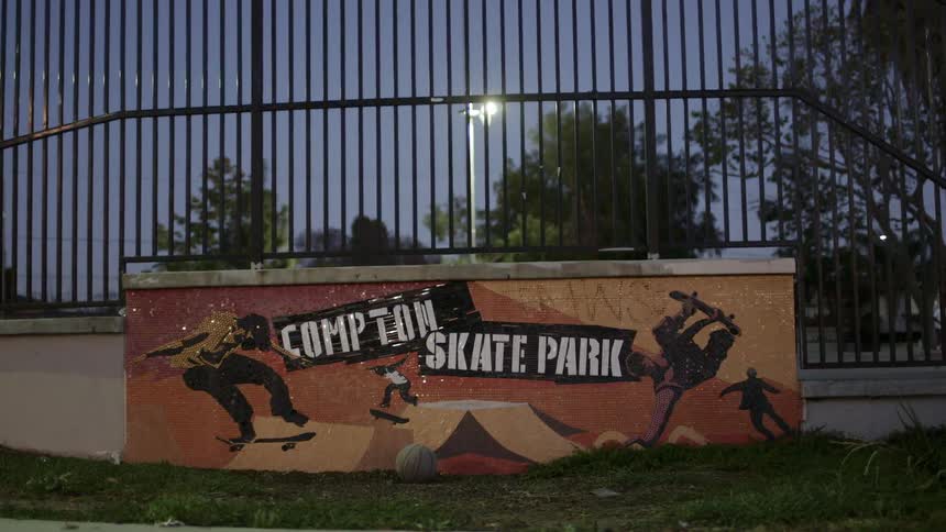 A skateboarder skates at a skating park