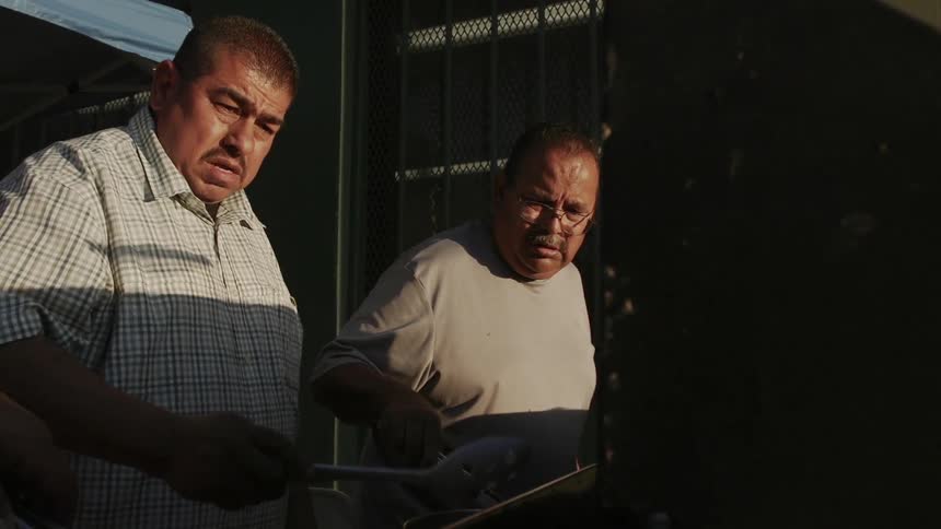 Two men cooking