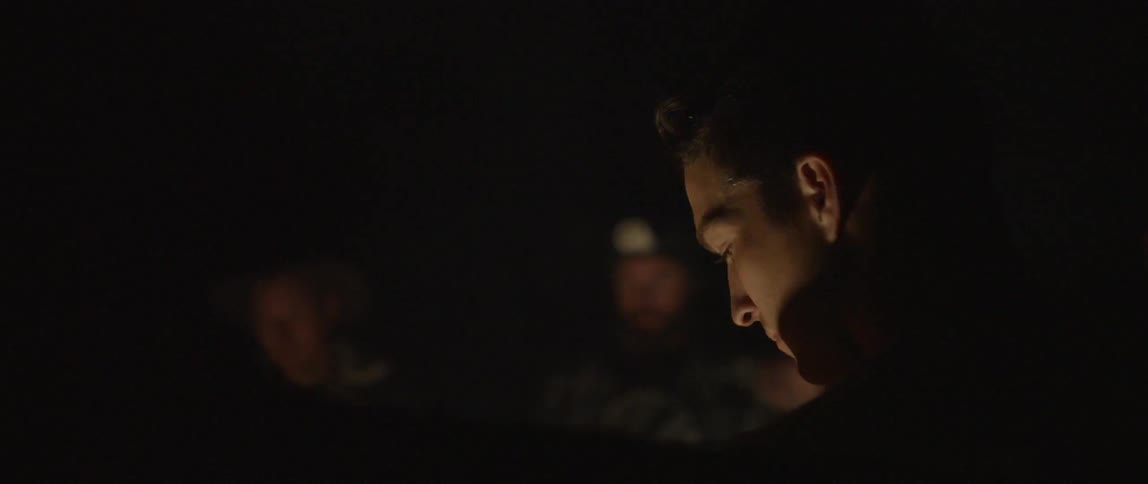 Men around a campfire at night