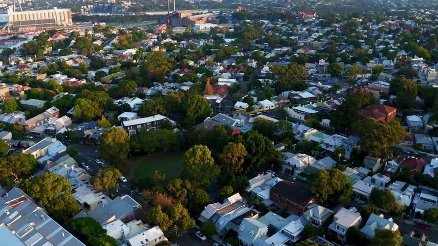 A neighborhood is sprawling out along the edges of a city in daylight