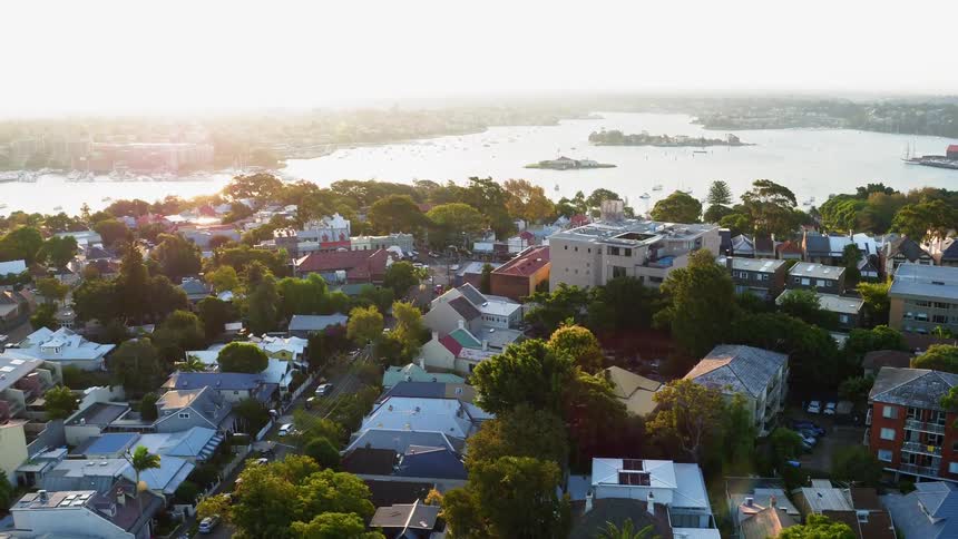 Sun shines on rooftops and streets of a coastal town