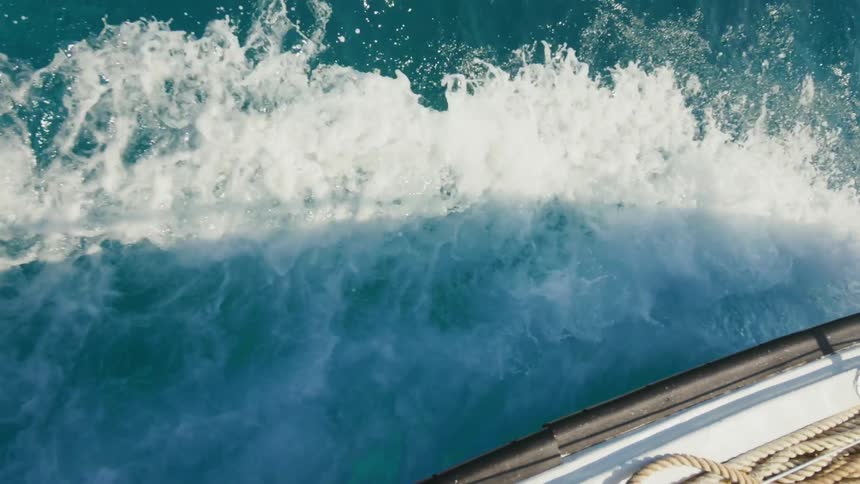 Water sprays off the side of a boat as it travels through