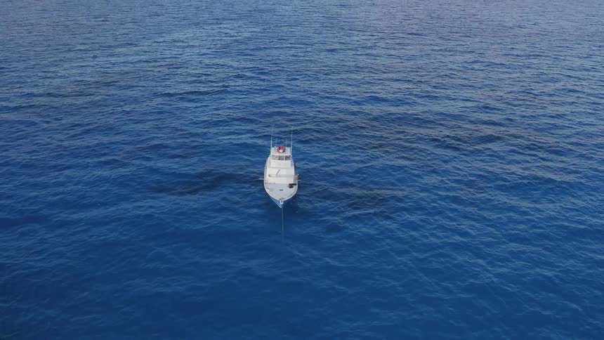 A boat is traveling on a calm ocean