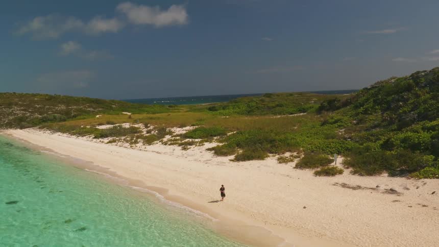 A man walks on the beach