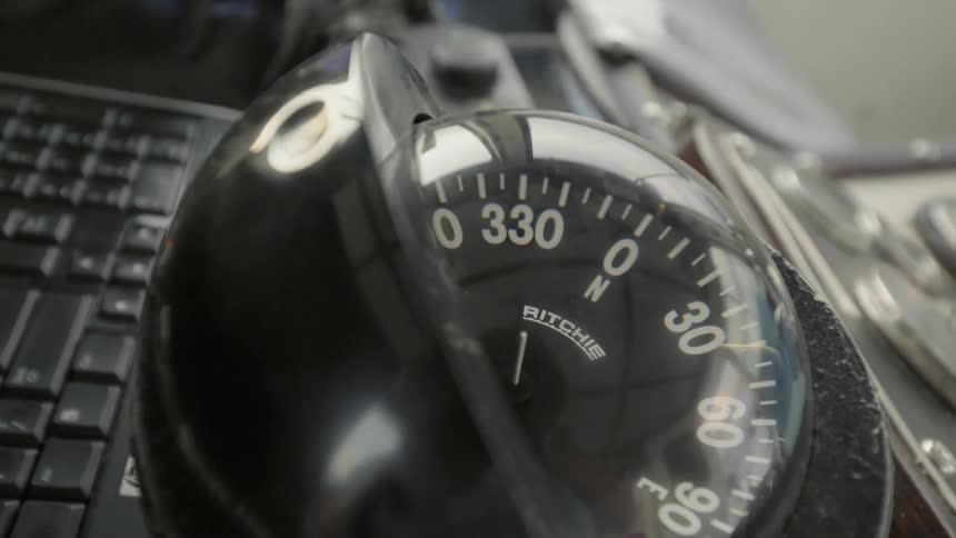 A compass sits near a keyboard