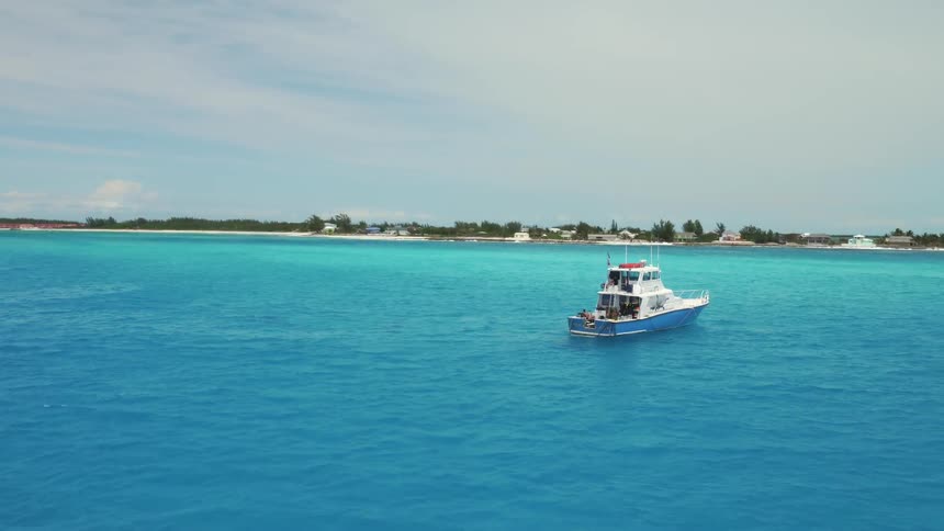A boat sails in the blue waters ahead
