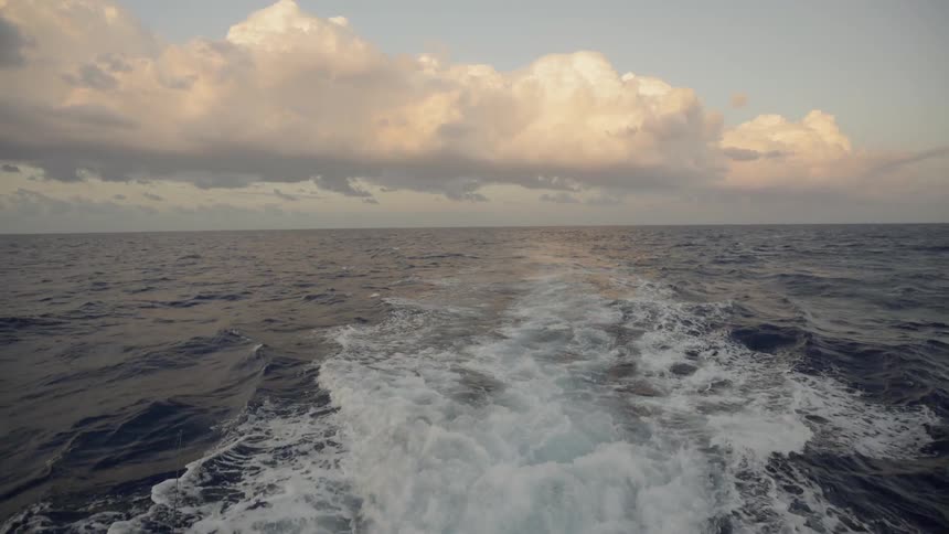 A boat kicks up water behind it