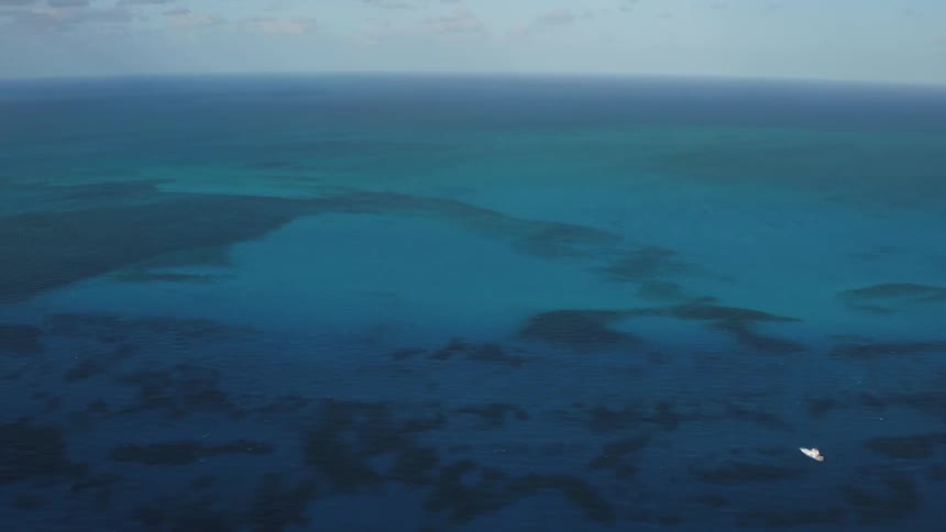 A boat sails on the open ocean