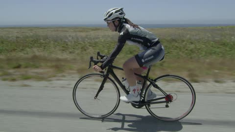 A woman is biking in the desert