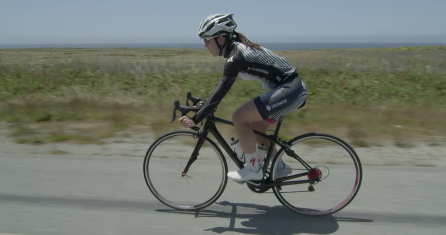 A woman is biking in the desert
