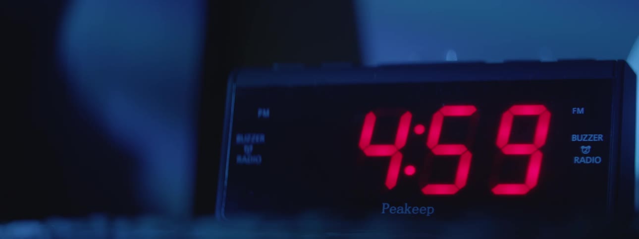 An alarm clock displays the time