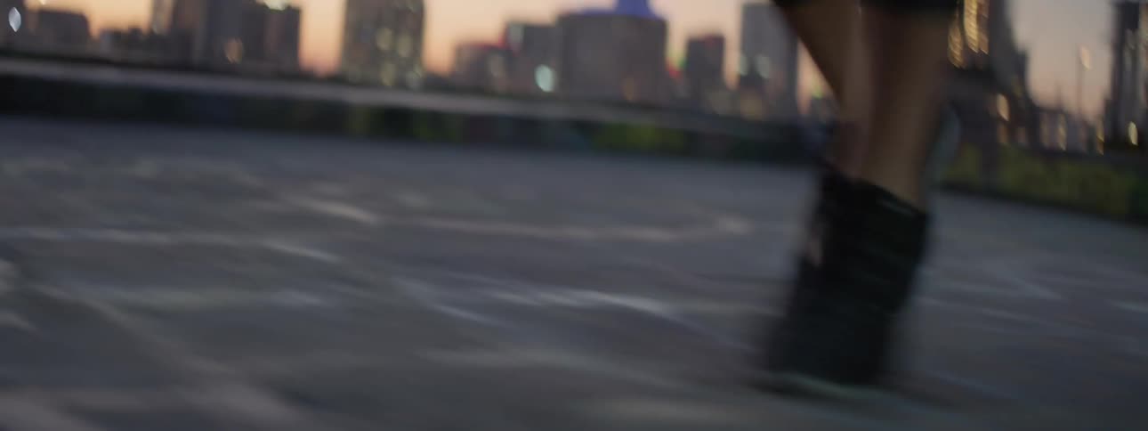 Woman's legs and feet moving quickly side to side outside at sunset