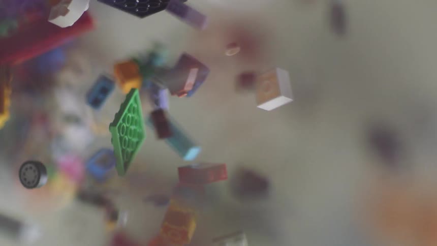 Pieces of building blocks and toy bricks are falling out of a container