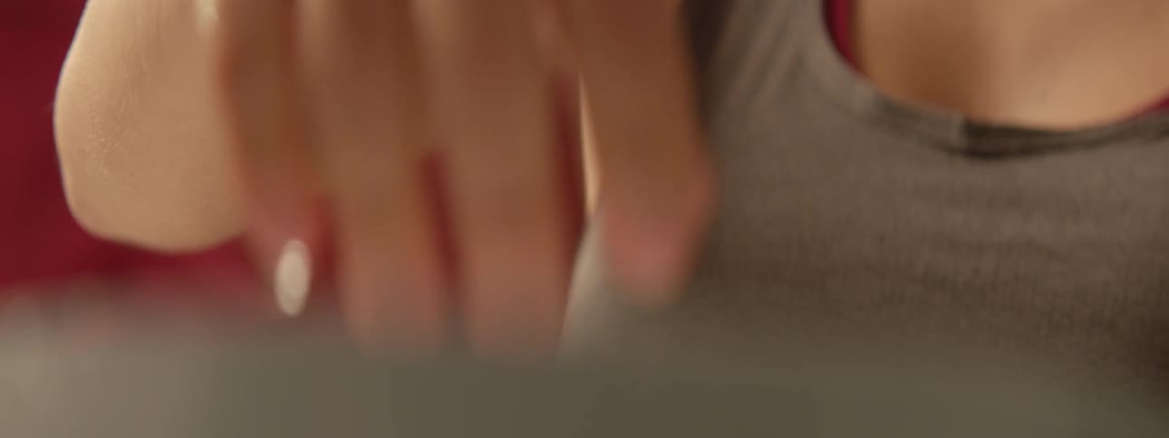 A woman dips her hand in ice water