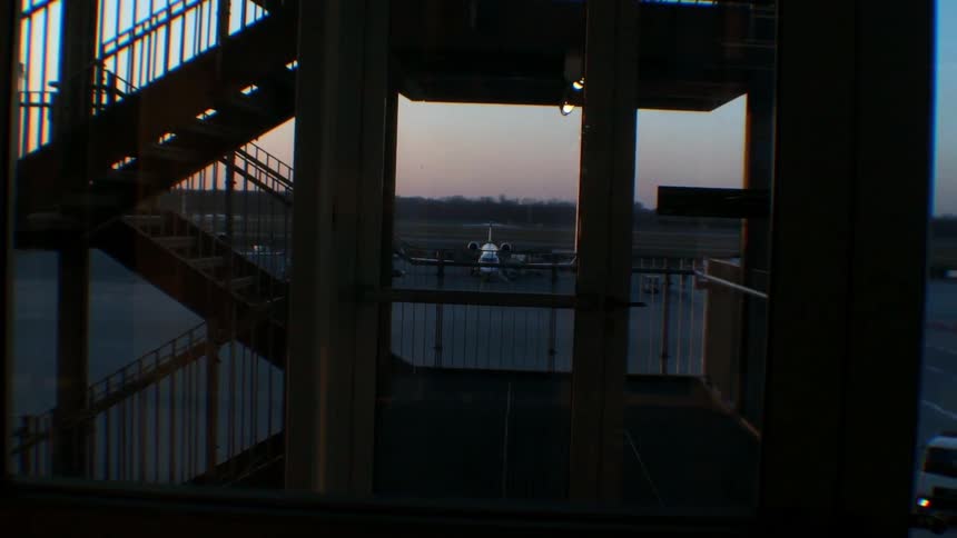 A building staircase is shown at sunset