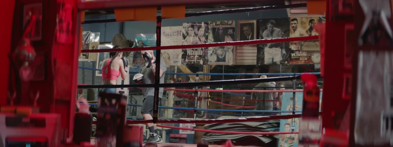 A man and woman box in a boxing ring