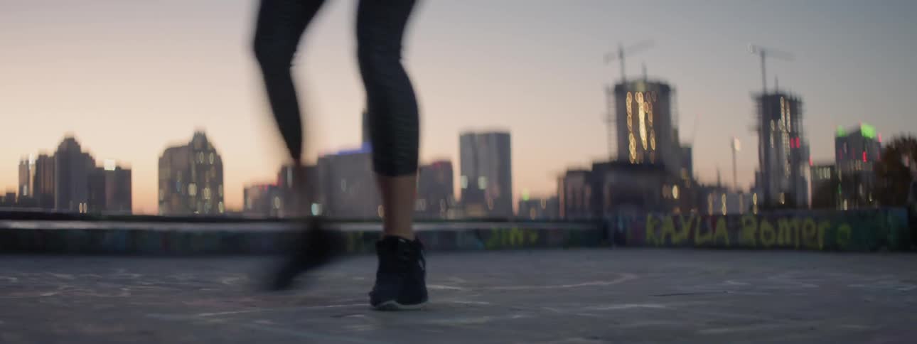 A woman does agility drills outside