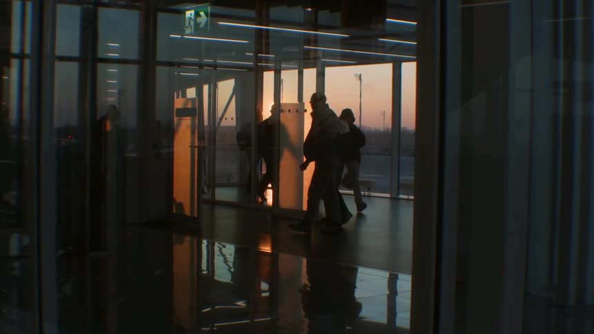 People walk through an airport