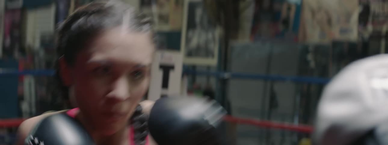 A woman boxing with a trainer