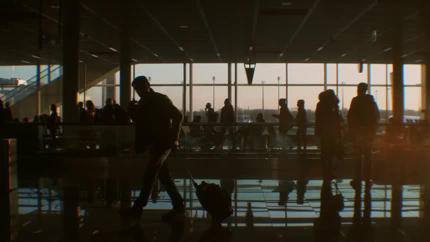 Large crowd of people walking in an airport