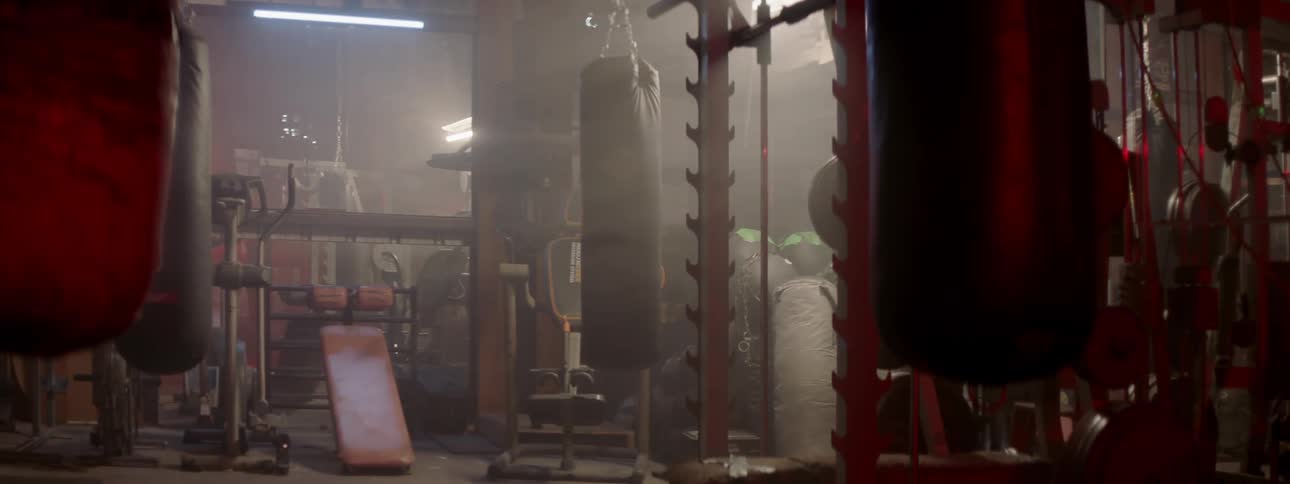 Lights are turned on in a gym with a punching bag