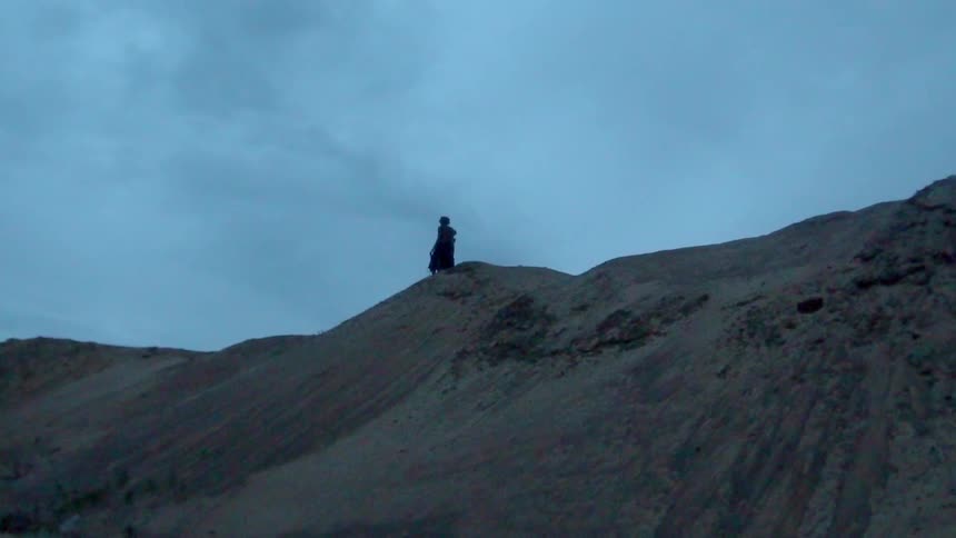 A person walks on top of a hill
