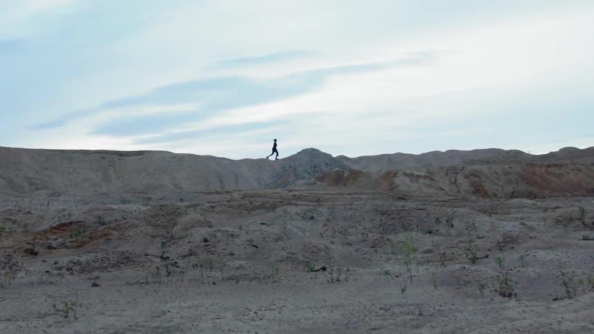 A person walks on top of a hill