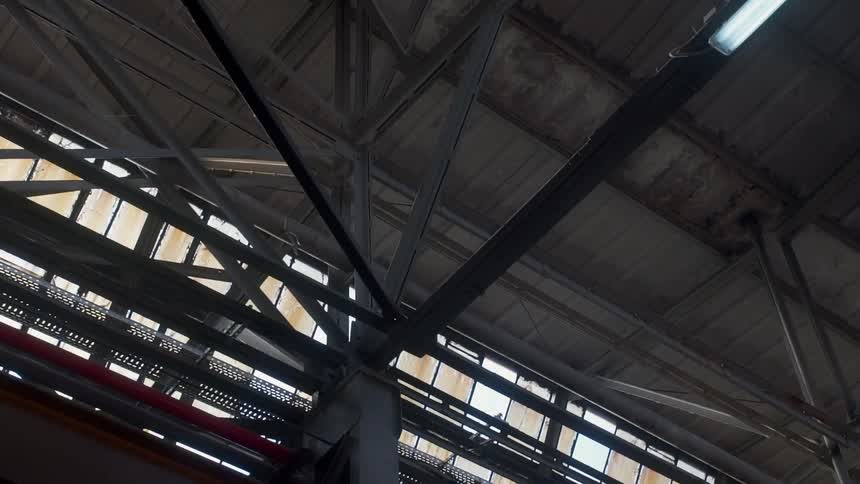 Rafters cover a warehouse ceiling