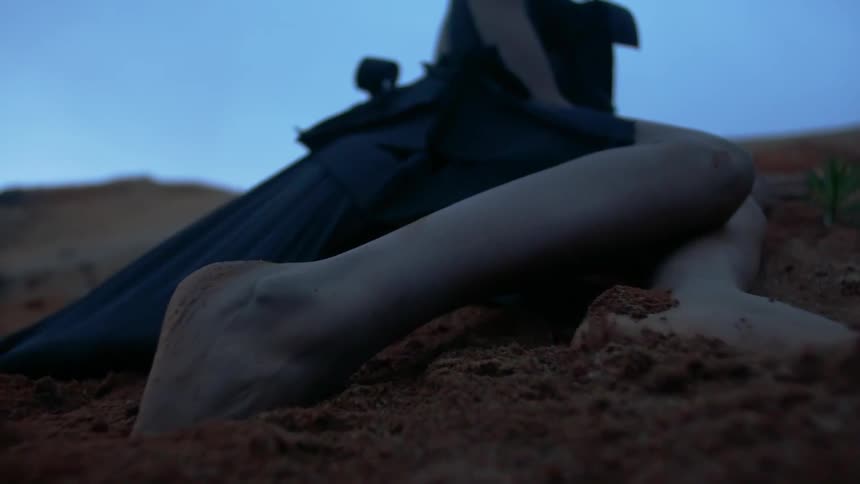 A person digs their feet into the dirt