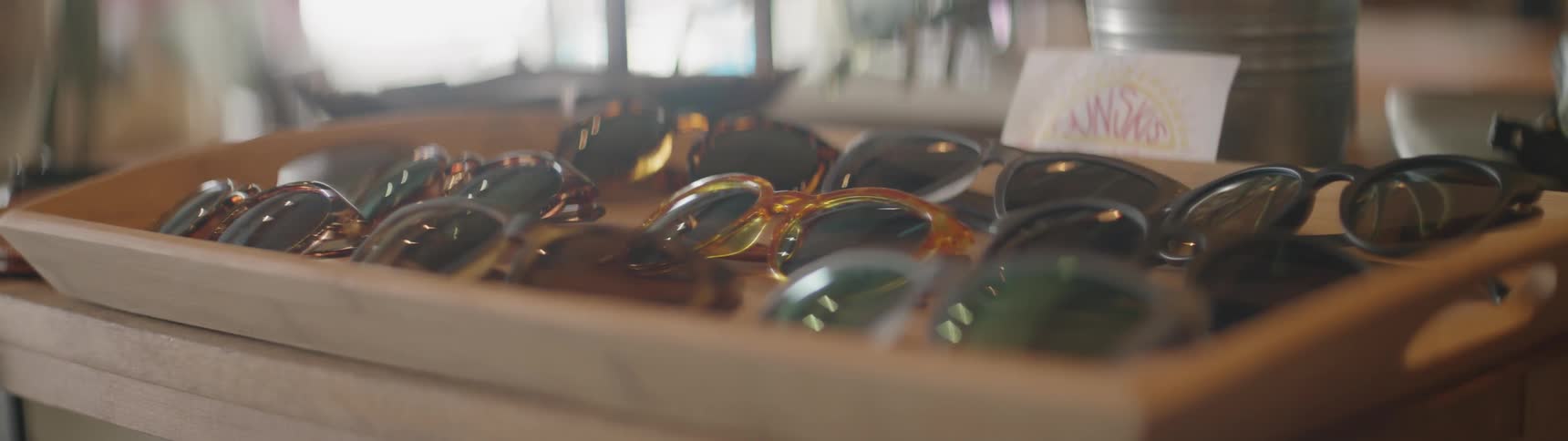 The counter in the shop is full of sunglasses