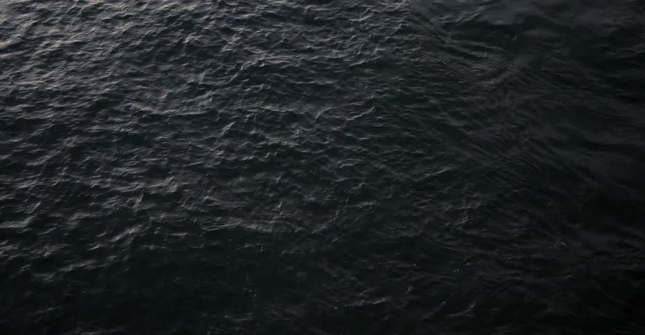 Small waves flow inward and out on the surface of the water