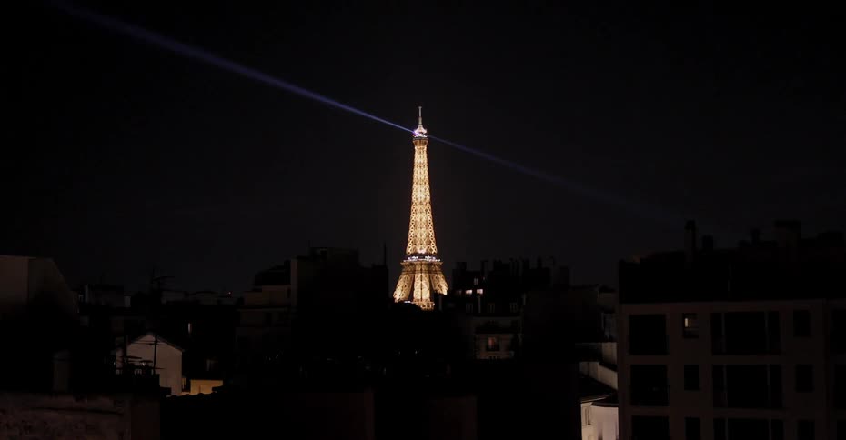 The eiffel tower illuminates the night sky