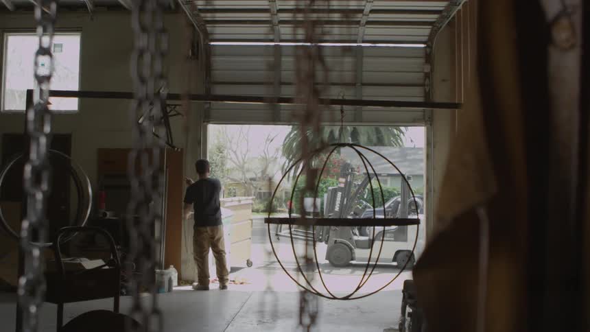 A person opening up a garage door