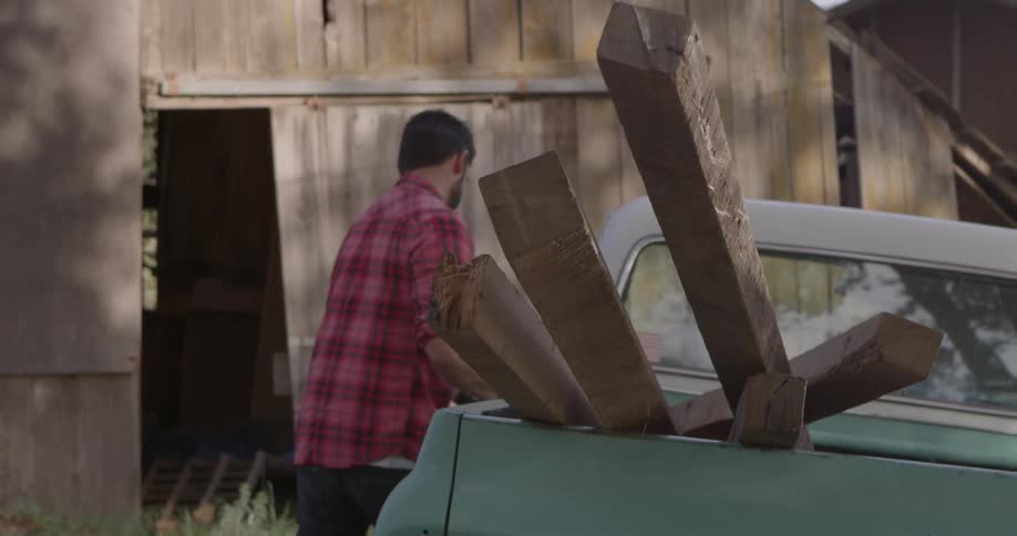 A man is gathering lumber
